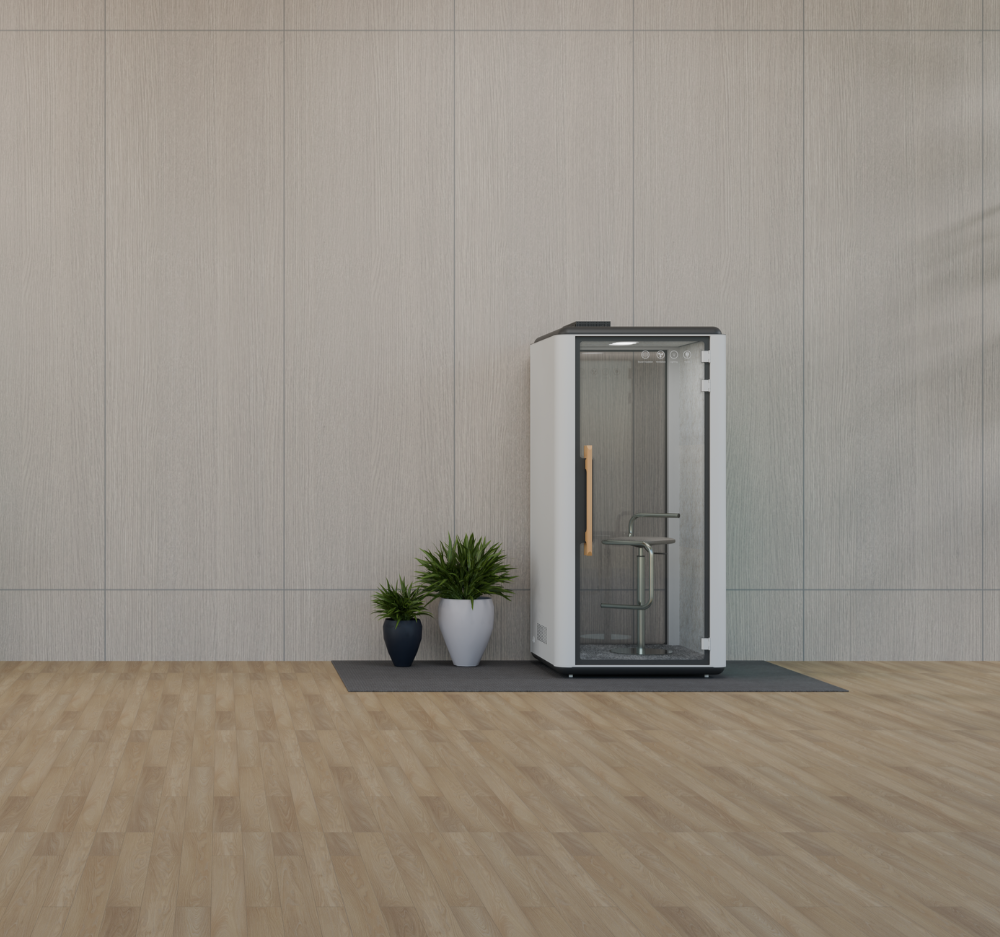 white soundproof booth next to 2 plants in an open area